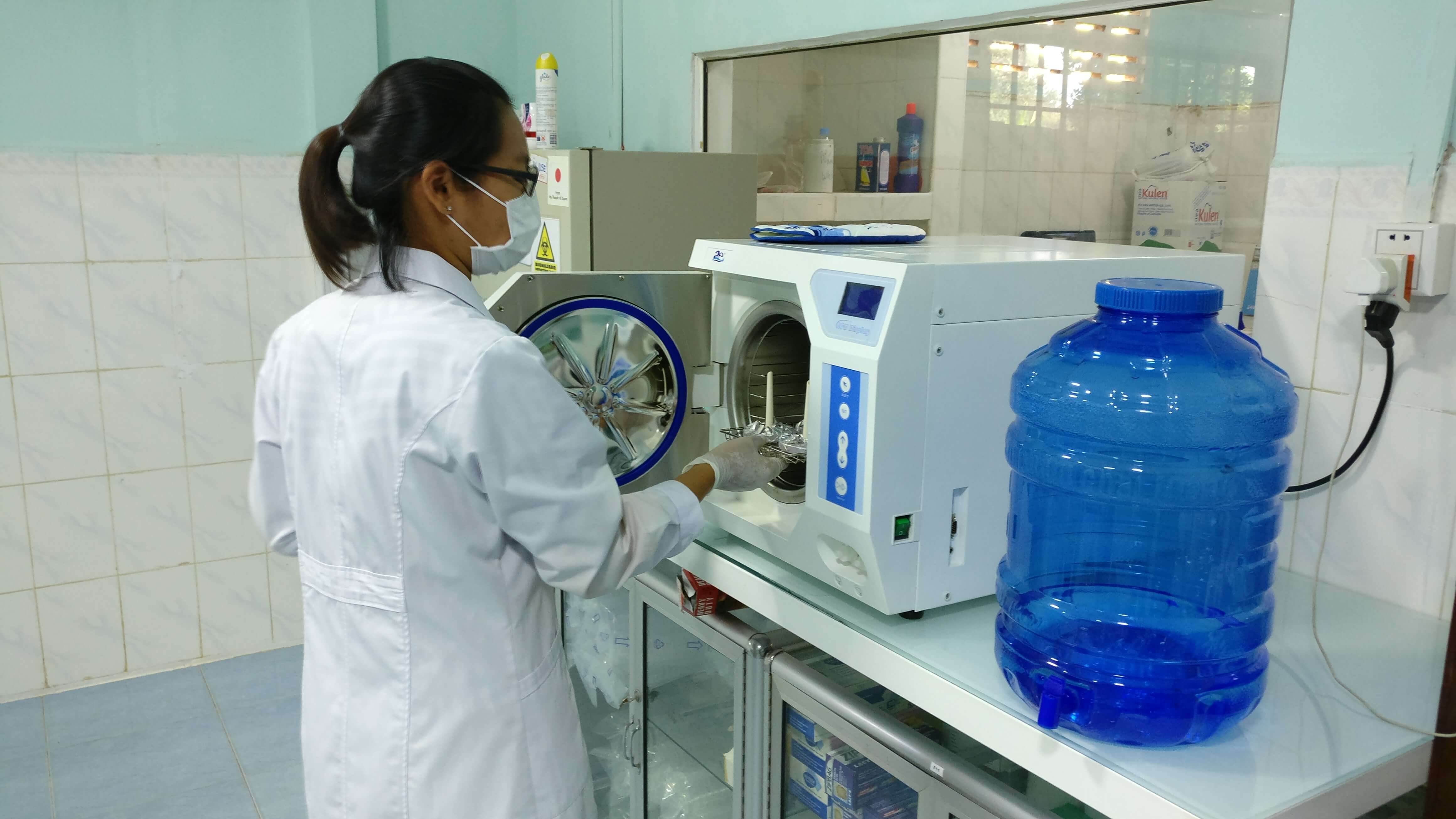 woman testing water in lab